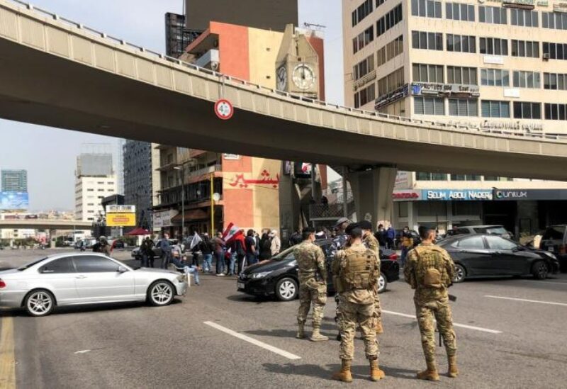 FILE PHOTO: Cars block a highway during a protest against the fall in Lebanese pound currency and mounting economic hardships, in Jal el-Dib, Lebanon March 9, 2021.