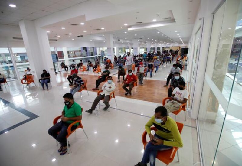 People wait in Sitra Mall to get vaccination against the coronavirus disease (COVID-19), in Sitra, Bahrain, March 23, 2021.