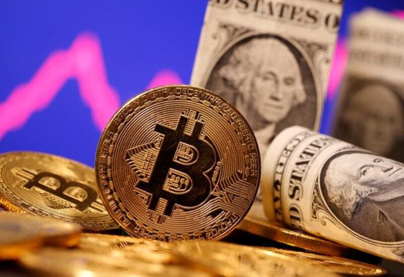 FILE PHOTO: A representation of virtual currency Bitcoin and U.S. One Dollar banknotes are seen in front of a stock graph in this illustration taken January 8, 2021.