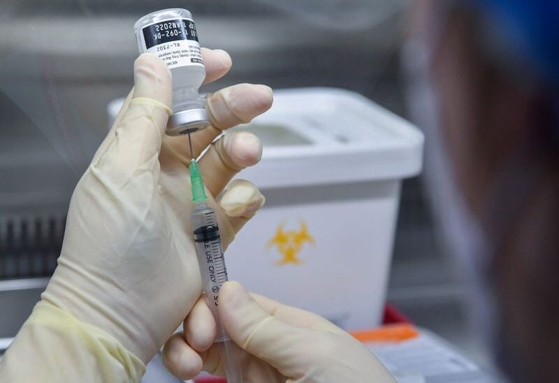 FILE PHOTO: A nurse fills a syringe with the Pfizer BioNTech vaccine Covid-19 at the National Medical Center vaccination center in Seoul, South Korea February 27, 2021.