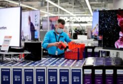 FILE PHOTO: An employee wearing a protective mask works at a Saturn electronic store as the coronavirus disease (COVID-19) lockdown measures are eased in Berlin, Germany, March 11, 2021.