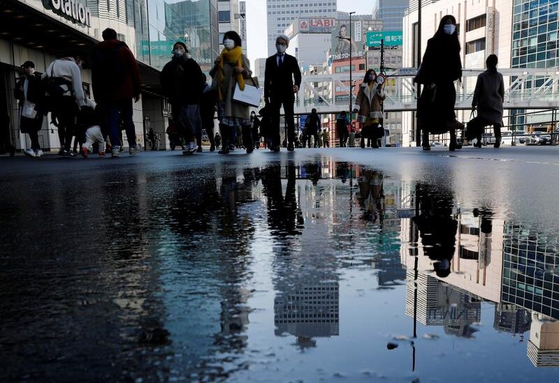 FILE PHOTO: Pedestrians wearing protective masks amid the coronavirus disease (COVID-19) outbreak, make their way in Tokyo, Japan, February 2, 2021.