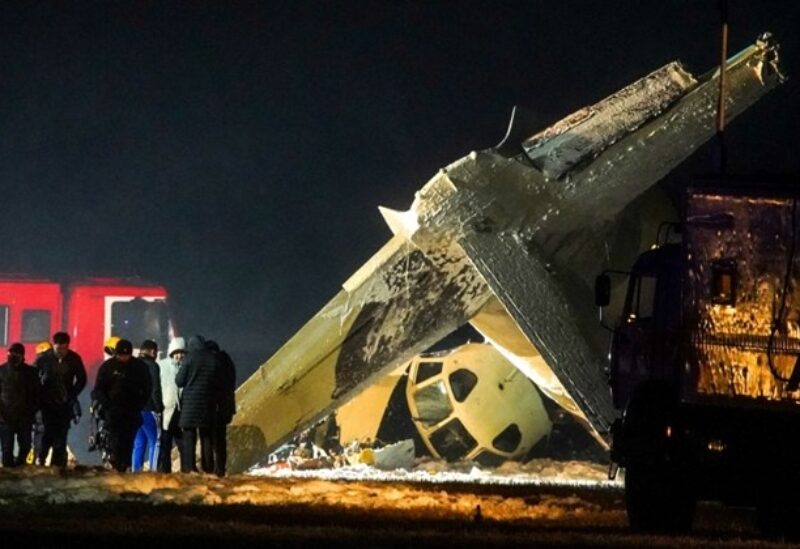 TOPSHOT - Kazakh investigators work at the site of the crash of a two-engine turboprop Antonov An-26 at the airport of Almaty, on March 13, 2021.