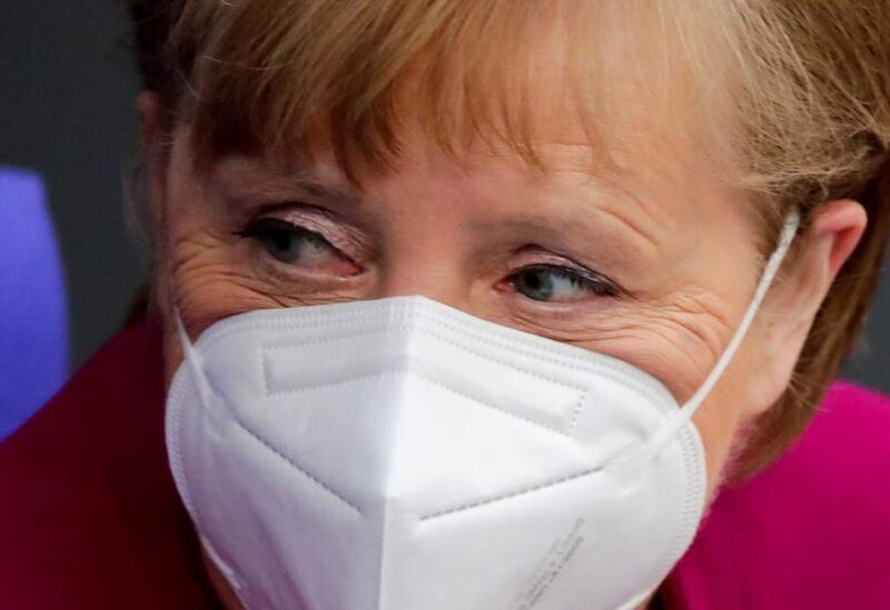 FILE PHOTO: German Chancellor Angela Merkel looks on at the country's parliament, the Bundestag, in Berlin, Germany, March 25, 2021.