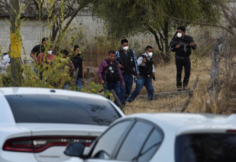 Police officers work at a crime scene where gunmen killed at least 13 Mexican police officers in an ambush, in Coatepec Harinas, Mexico March 18, 2021.