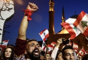 Protesters wave Lebanese flag near Beirut's Al Amin mosque
