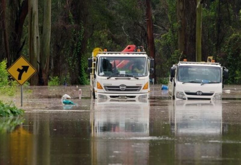 A still image taken from video shows trucks stuck in a flooded road, following heavy rains in Taree, New South Wales, Australia March 20, 2021.