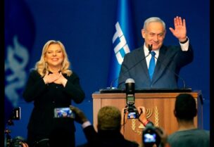Israeli Prime Minister Benjamin Netanyahu and his wife Sara address supporters at the Likud party campaign headquarters in the coastal city of Tel Aviv early on March 3, 2020, after polls officially closed.