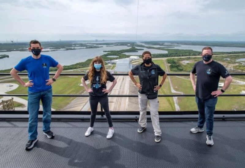Jared Isaacman, Hayley Arceneaux, Sian Proctor and Chris Sembroski pose for a photo at the SpaceX launch tower at NASA's Kennedy Space Center at Cape Canaveral, Florida U.S., March 29, 2021 in this handout image provided by SpaceX. Picture taken March 29, 2021.