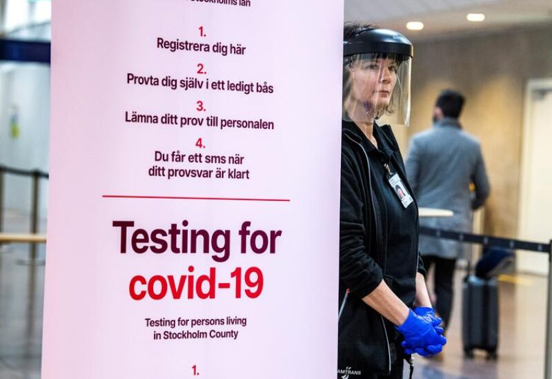 FILE PHOTO: Asa Wernsten works at a coronavirus disease (COVID-19) test station for the for arriving passengers at Arlanda airport, north of Stockholm, Sweden February 22, 2021.