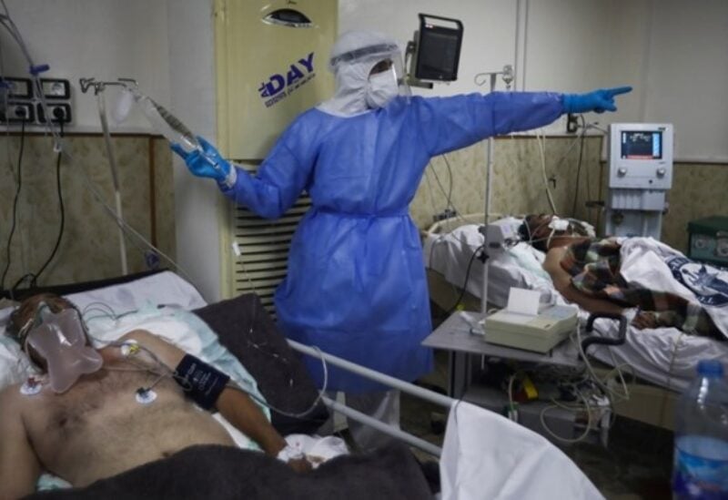 FILE PHOTO: In this Nov. 14, 2020 picture, a medic cares for corona patients at a hospital in Idlib, Syria.