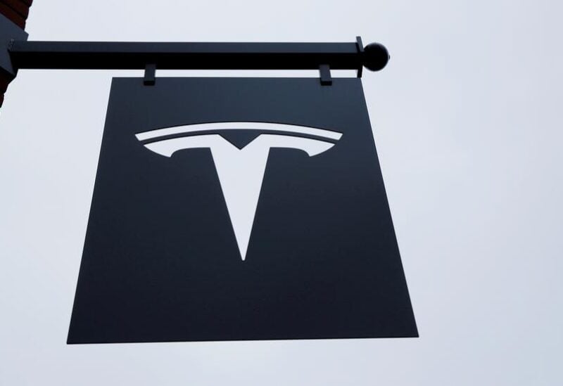 FILE PHOTO: A Tesla logo hangs on a building outside of a Tesla dealership in New York, U.S., April 29, 2016.