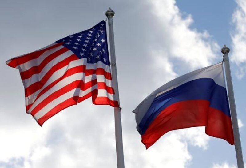 FILE PHOTO: Russian and U.S. state flags fly near a factory in Vsevolozhsk, Leningrad Region, Russia March 27, 2019.