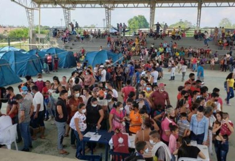 Venezuelan migrants are seen inside a coliseum where a temporary camp is installed, after fleeing their country due to military operations, according to the Colombian migration agency, in Arauquita, Colombia March 22, 2021.