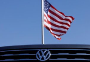 FILE PHOTO: A Volkswagen logo is show with an American flag at a car dealership in Carlsbad, California, U.S., September 23, 2020.