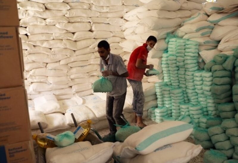 FILE PHOTO: Workers prepare foodstuff for beneficiaries at a food distribution center supported by the World Food Program in Sanaa, Yemen, June 3, 2020.