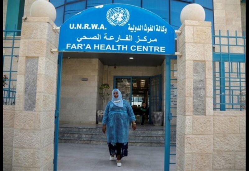 A Palestinian health worker leaves a health center run by the UNRWA