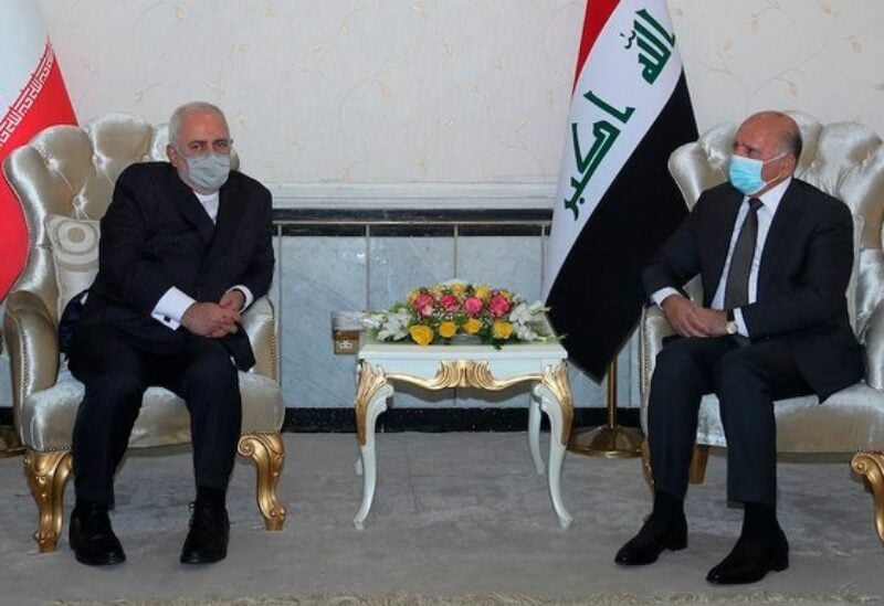 Iraqi Foreign Minister Fouad Hussein and his Iranian counterpart Mohammad Javad Zarif