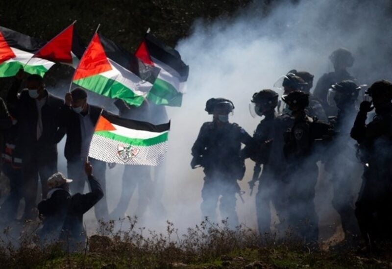 Israeli border police officers and Palestinians clash during a protest against the expansion of Israeli Jewish settlements near the West Bank town of Salfit