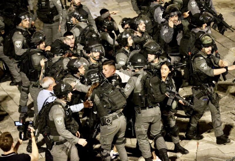 Israeli forces crowd around a Palestinian man in Jerusalem