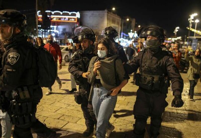 Israeli police arresting a palestinian protester