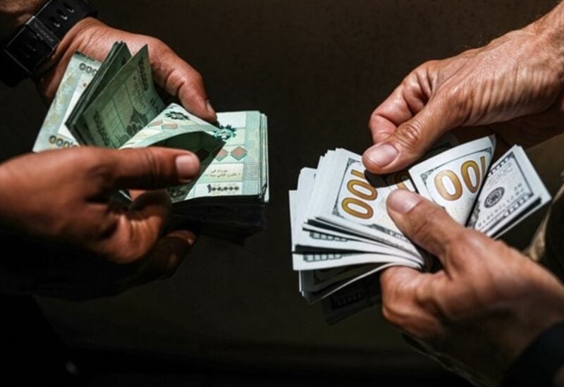 People exchange Lebanese pound and dollar notes on the black market in Beirut