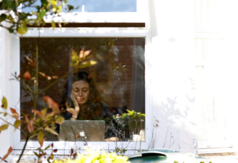 FILE PHOTO: A woman working from her computer at home is seen as the spread of the coronavirus disease (COVID-19) continues, Oxford, Britain, March 31, 2020.