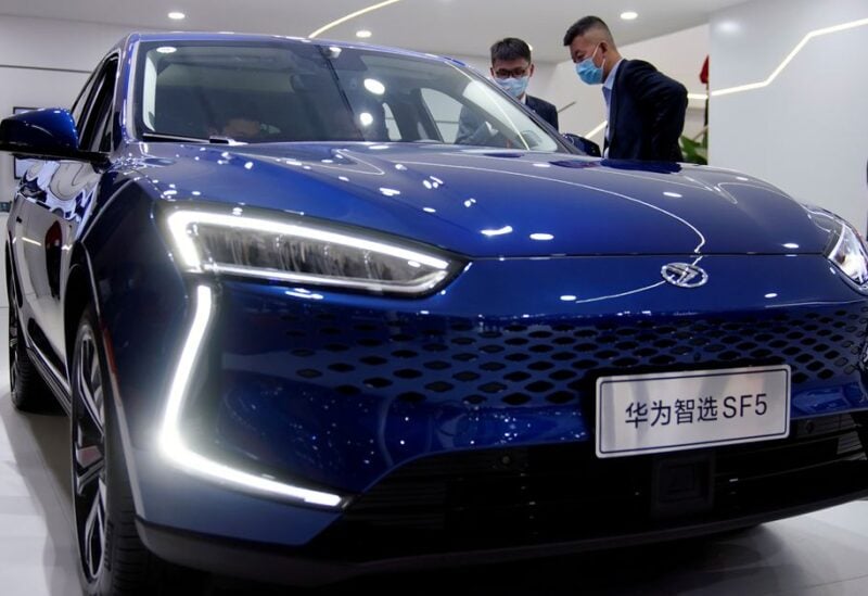 People check a Seres Huawei Smart Selection SF5 electric vehicle (EV) displayed during the Auto Shanghai show in Shanghai, China April 19, 2021. REUTERS