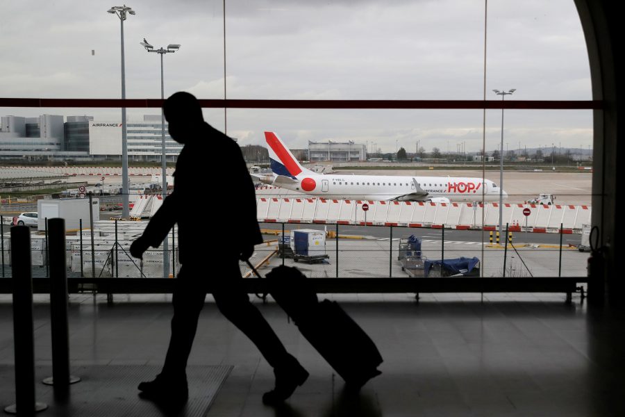 FILE PHOTO: A man walks inside a Terminal at Paris Charles de Gaulle airport in Roissy near Paris as France closed its borders to travellers outside European Union due to restrictions against the spread of the coronavirus disease (COVID-19) in France, February 5, 2021. REUTERS/Gonzalo Fuentes