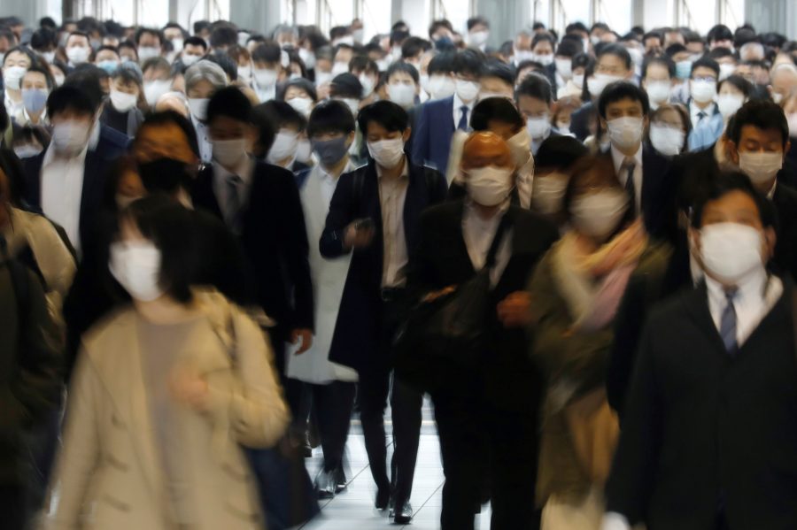 Commuters wearing protective face masks, amid the coronavirus disease (COVID-19) pandemic, make their way in Tokyo, Japan, April 6, 2021.