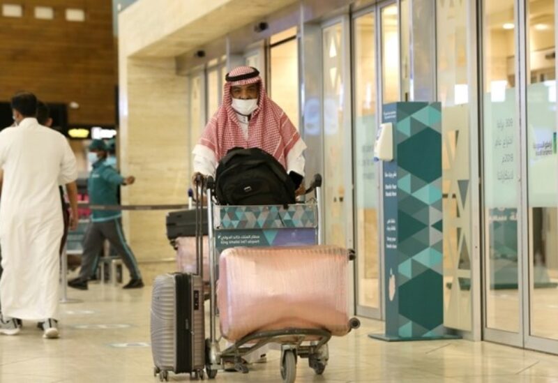 A Saudi man wearing a face mask is seen with his luggage as he arrives at the King Khalid International Airport, after Saudi authorities lift the travel ban on its citizens after fourteen months due to Coronavirus (COVID-19) restrictions, in Riyadh, Saudi Arabia, May 16, 2021. REUTERS/Ahmed Yosri