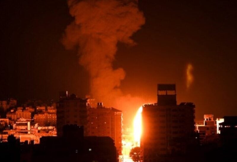 Fire and smoke rise above buildings in Gaza City as Israeli warplanes target the Palestinian enclave, early on May 17, 2021. (Photo by MAHMUD HAMS / AFP)