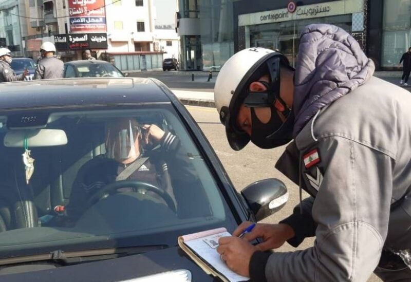 A member of Lebanon's Internal Security Forces (ISF) giving a ticket to a citizen