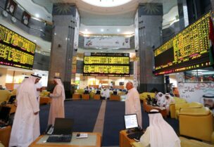 Investors monitor screens displaying stock information at the Abu Dhabi Securities Exchange June 25, 2014. REUTERS/Stringer/File Photo