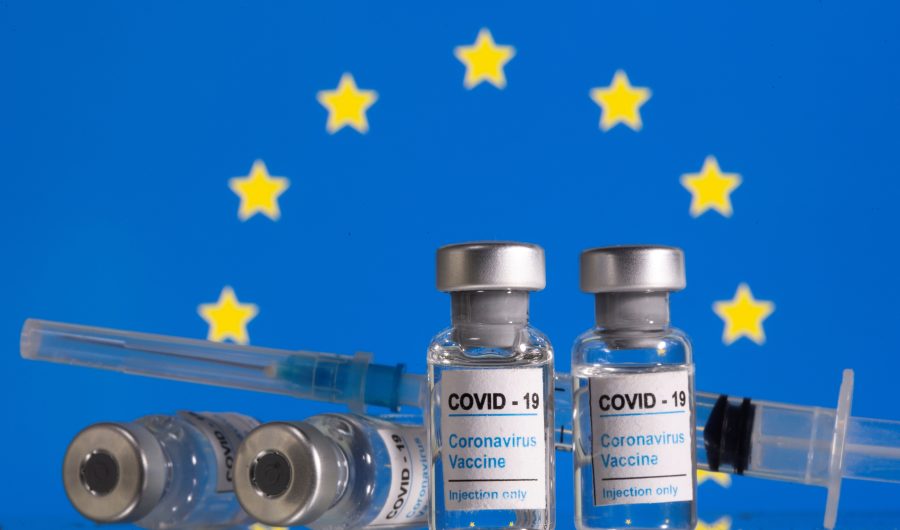 FILE PHOTO: Vials labelled "COVID-19 Coronavirus Vaccine" and sryinge are seen in front of displayed EU flag in this illustration taken, February 9, 2021. REUTERS/Dado Ruvic/Illustration/File Photo
