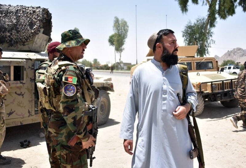 Afghan security personnel stand guard along the road amid ongoing fight between Afghan security forces and Taliban fighters in Kandahar on July 9, 2021. (Stock image)