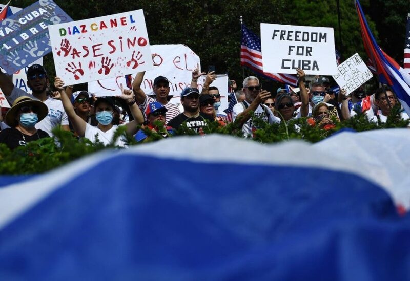 People gather for a Cuba protest as people wave signs and wear Cuban flags in Lafayette Square near the White House in Washington DC, US, on July 26, 2021. (Brendan Smialowski/AFP)
