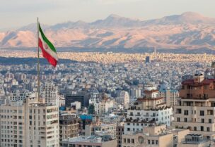 An Iranian flag waves above the Iranian capital Tehran. (iStock)