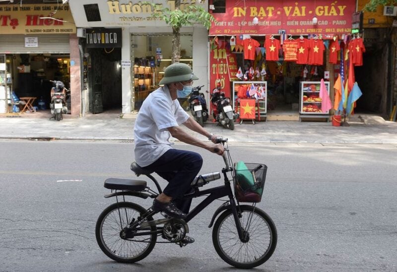 A man rides a bike on an empty street amid the coronavirus (COVID-19) pandemic, in Hanoi, Vietnam, May 31. REUTERS/Thanh Hue