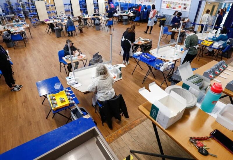 Students take lateral flow tests as health workers supervise at Weaverham High School, as the coronavirus disease (COVID-19) lockdown begins to ease, in Cheshire, Britain, March 9, 2021. (Reuters)