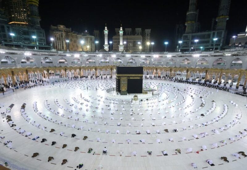 Muslim worshippers gather for prayers around the Kaaba, the holiest shrine in the Grand mosque complex in the Saudi city of Mecca during the first day of the Muslim holy fasting month of Ramadan on April 13, 2021. (AFP)