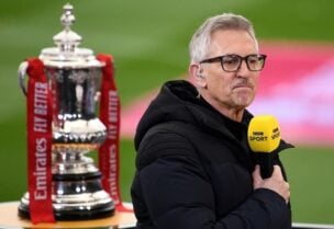 Gary Lineker performing media duties next to the FA Cup trophy before the match in March 2021. (Reuters)