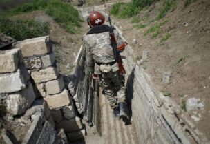 A file photo shows ethnic Armenian soldiers walk in a trench at their position near Nagorno-Karabakh's boundary, April 8, 2016. (Reuters)