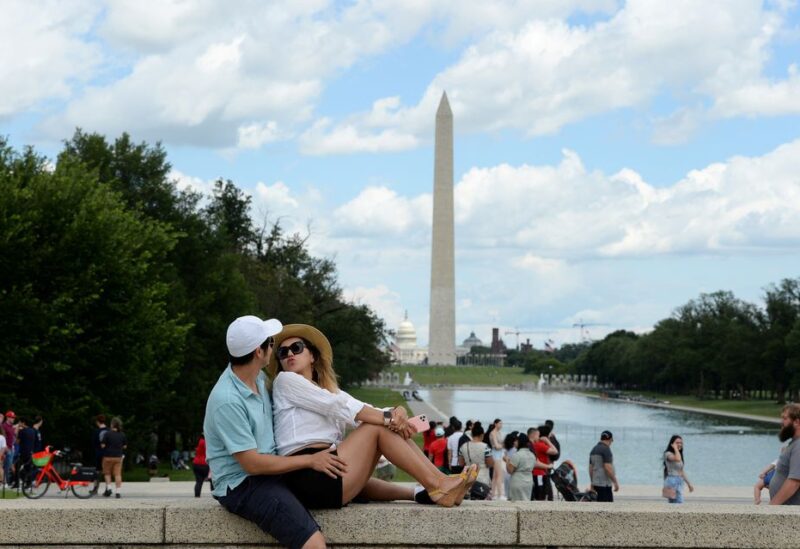 Daniel Flanagan and Zhadyra Darbayeva enjoy the weather at the Lincoln Memorial in Washington, U.S., July 3, 2021. REUTERS/Mary F. Calvert