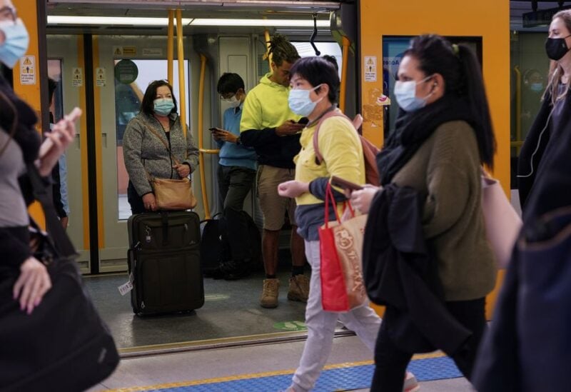 Commuters wear protective face masks on public transit at Central Station following the implementation of new public health regulations from the state of New South Wales, as the city grapples with an outbreak of the coronavirus disease (COVID-19) in Sydney, Australia, June 23, 2021. REUTERS/Loren Elliott