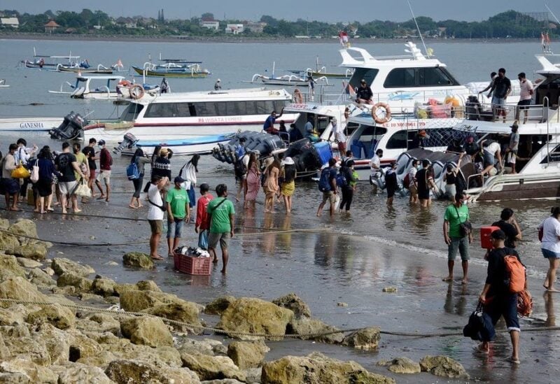 This picture taken on January 7, 2021 shows tourists preparing to board a fast boat from Sanur beach near Denpasar on Indonesia's resort island of Bali. (Sonny Tumbelaka/AFP)