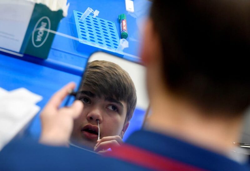 Year 10 student, Isaac O'Hare, 15, takes a coronavirus disease (COVID-19) test at Harris Academy Beckenham , ahead of full school reopening in England as part of lockdown restrictions being eased, in Beckenham, south east London, Britain, March 5, 2021. (Reuters)