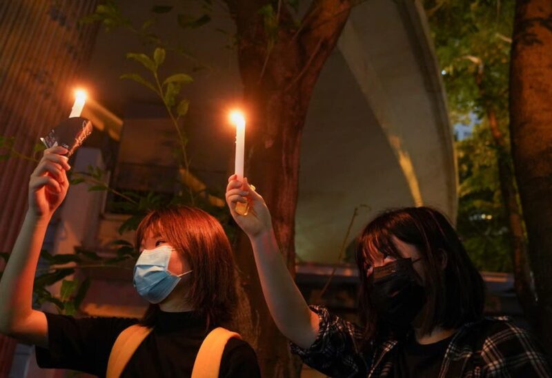 People hold candles at Victoria Park on the 32nd anniversary of the crackdown on pro-democracy demonstrators at Beijing's Tiananmen Square in 1989, in Hong Kong, China, on June 4, 2021. (Reuters)