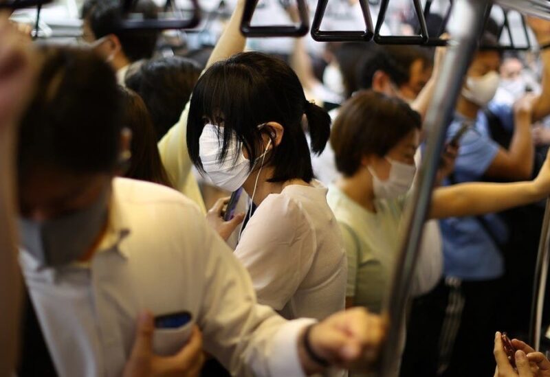 People wearing protective masks amid the coronavirus pandemic take a train on the outskirts of Tokyo, Japan, on August 5, 2021. (Reuters)