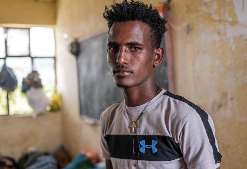 Tilahun Alemu, a youngster displaced by fighting in northern Ethiopia, is portrayed in a classroom at the Addis Fana School where he is temporary sheltered, in the city of Dessie, Ethiopia, on August 23, 2021. (AFP)
